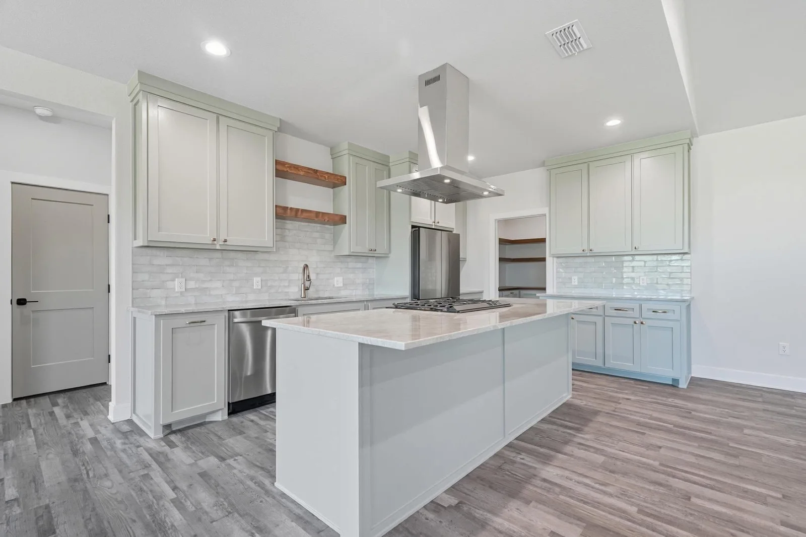 Sage green painted kitchen cabinets