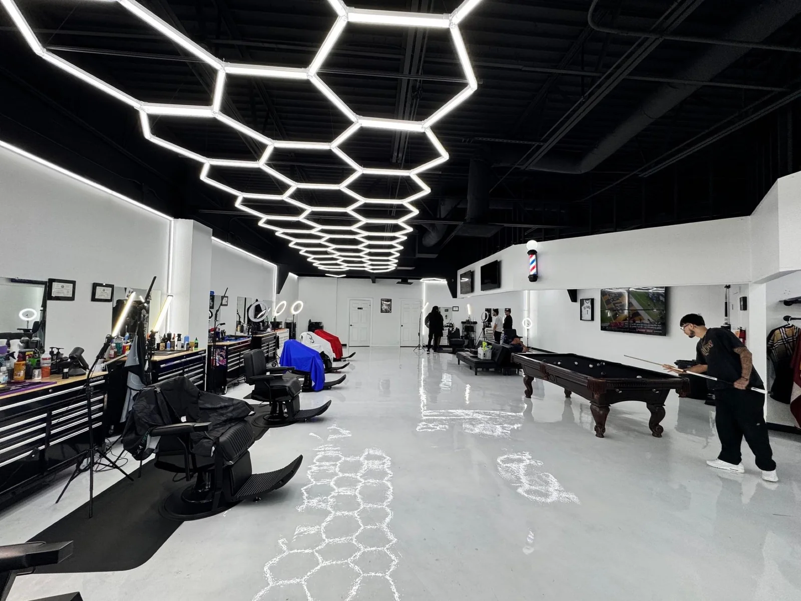 Commercial barbershop interior with a dramatic black ceiling