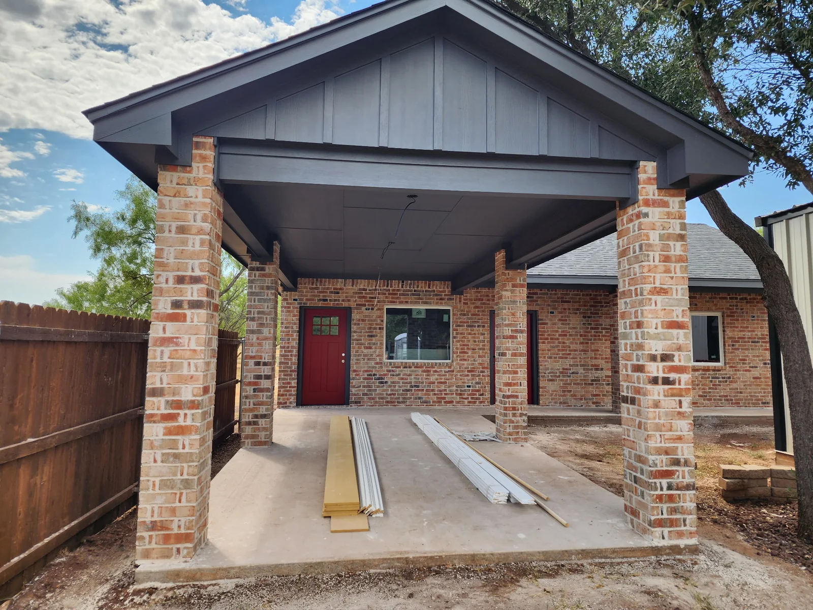 Dark gray gable and covered entry with brick columns